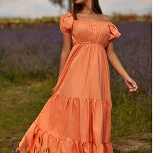 The Marni Maxi Dress showcases a bright orange hue